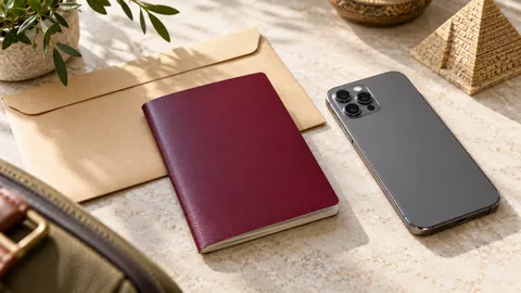 Unmarked passport booklet, smartphone camera and document envelope on a desk